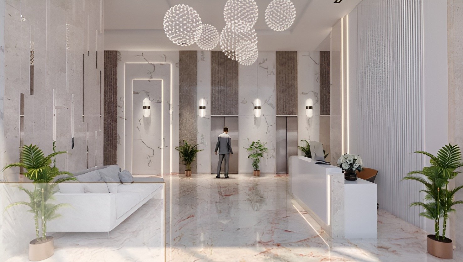 Luxury reception lobby with white marble flooring, chandelier lighting, and premium lift access